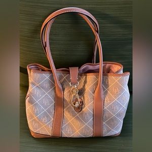Dooney & Bourke Turn Lock Signature with DB logo canvas with leather trim.